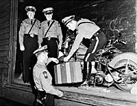 1940s Fleet History 1940s Troopers load a suitcase and motorcycle onto a train car