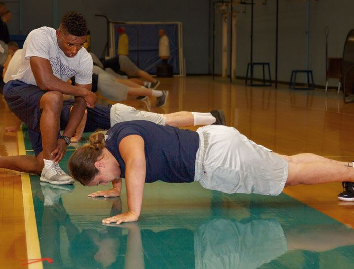recruit doing supervised plank exercise