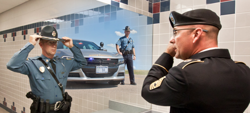 Man in Army uniform sees himself in KHP honor guard uniform in mirror